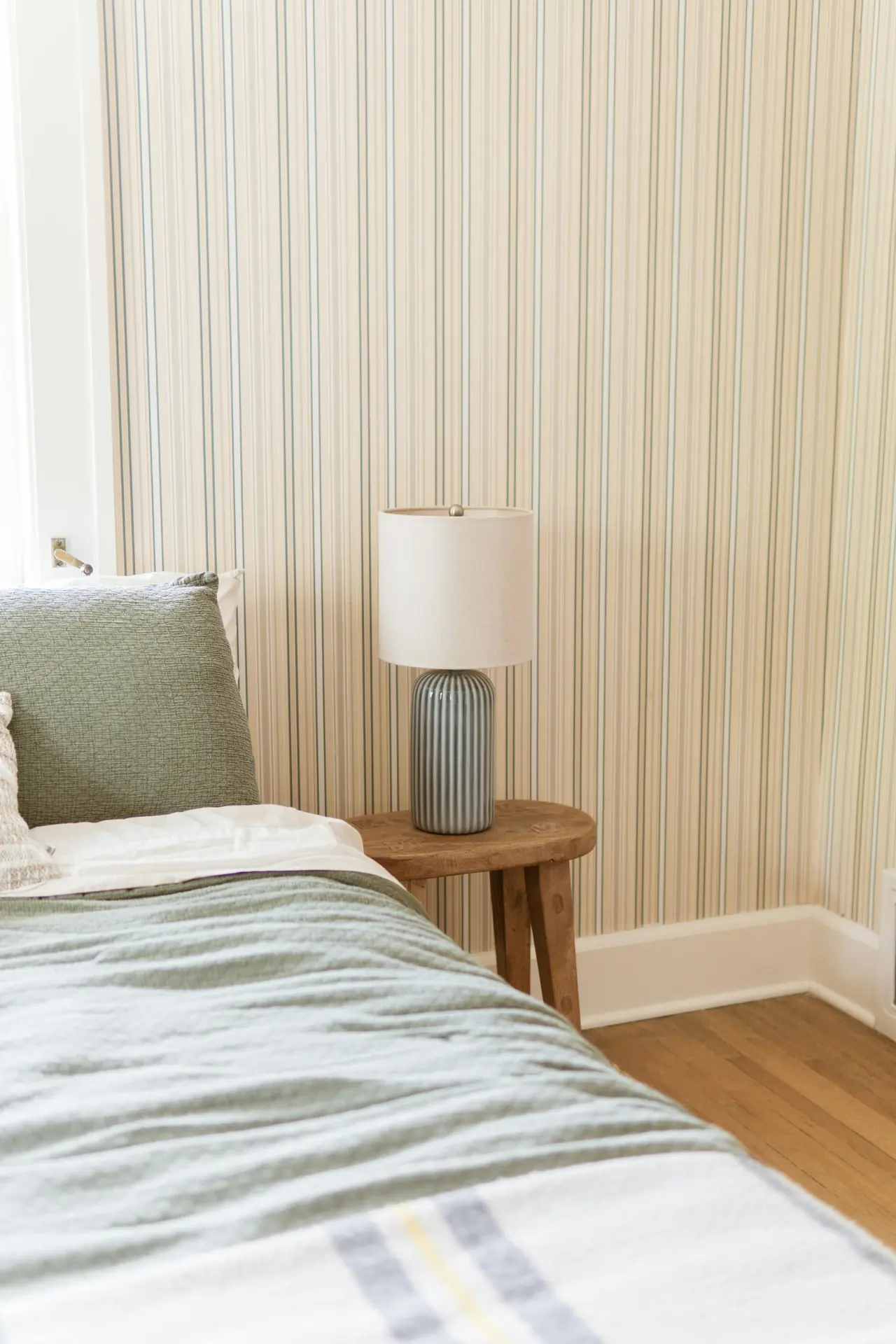 Striped lamp on a bedside table