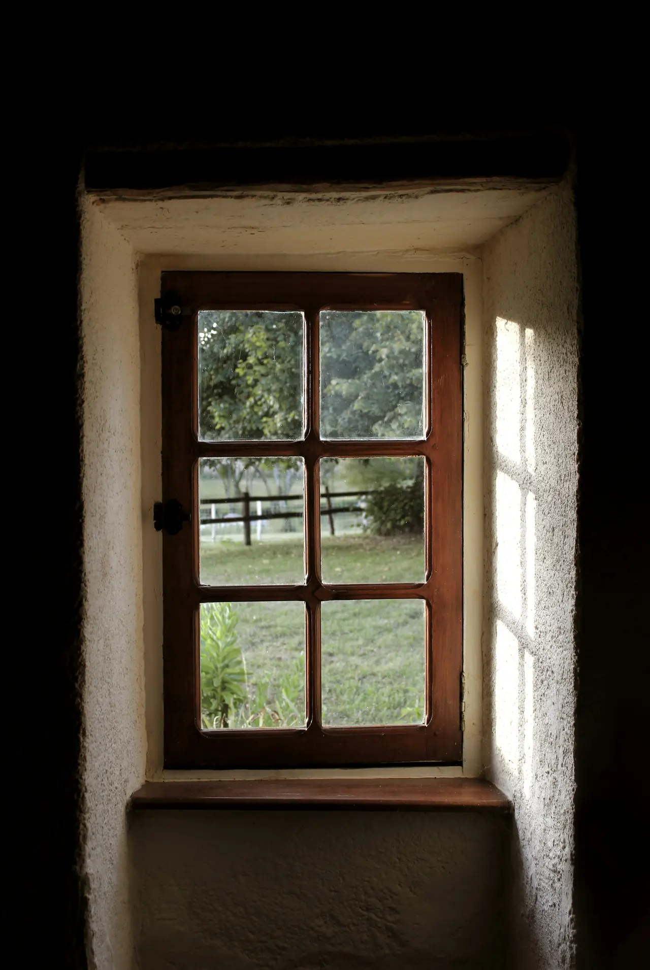 A deep window in a whitewashed wall